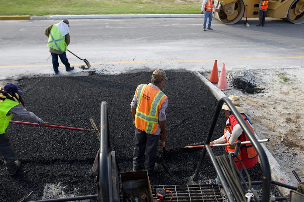 men applying asphalt