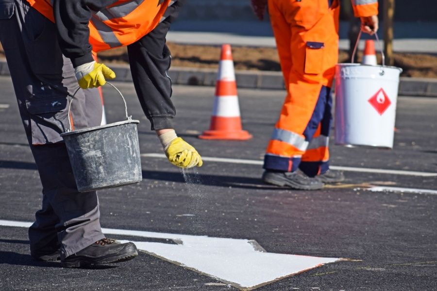 road workers painting a highway