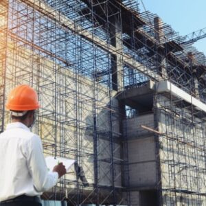 a real estate officer looking at a contruction building