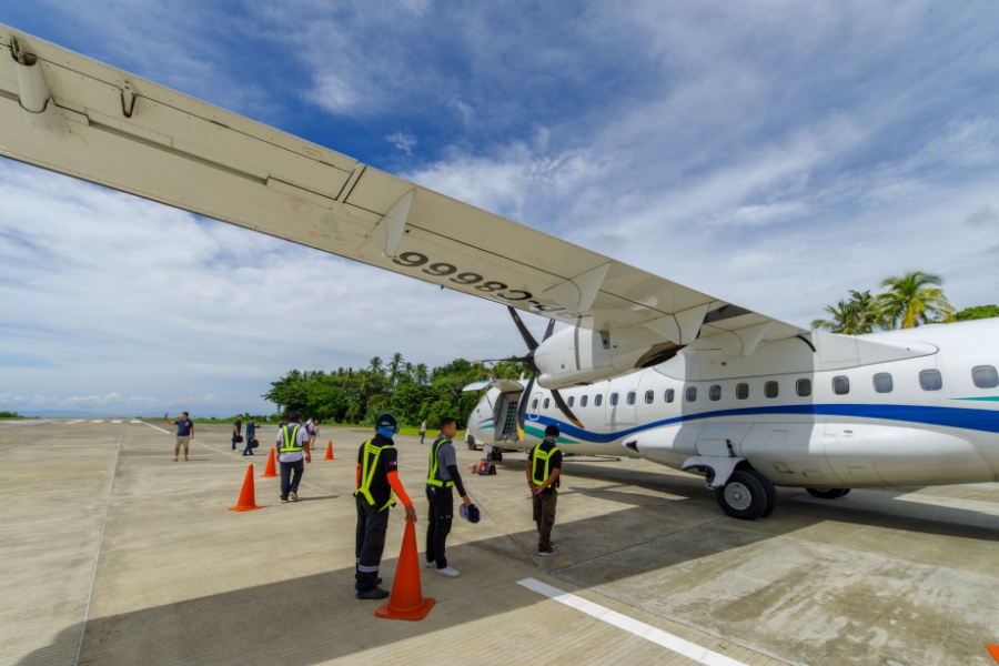 airport officers standing beside an airplane