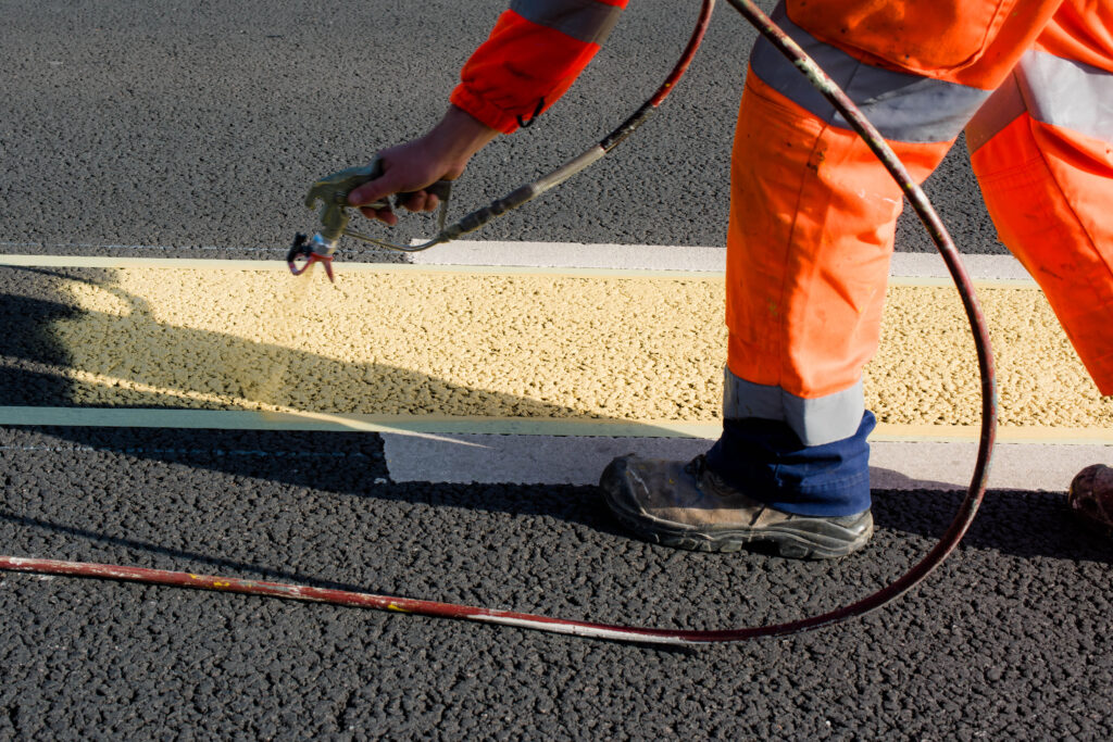 a road safety officer putting in bitumen