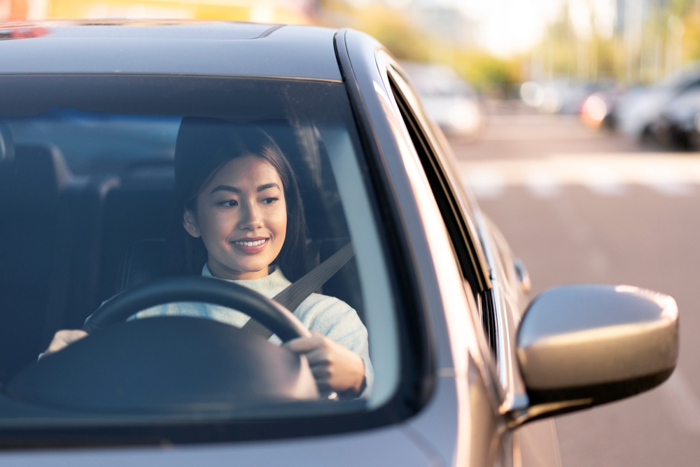 a woman driving on a public road